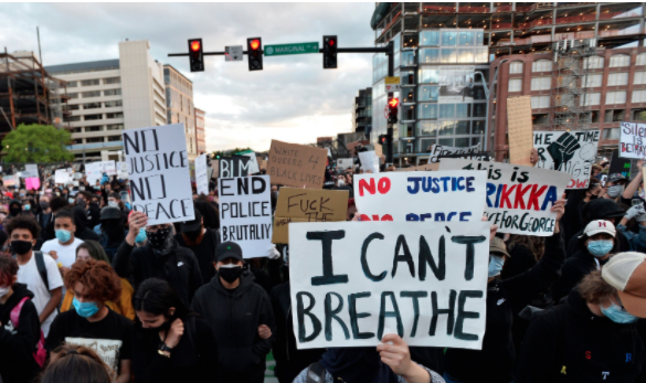 Protesters hold up signs during a demonstration over the death of George Floyd in Boston, Massachusetts, 31 May