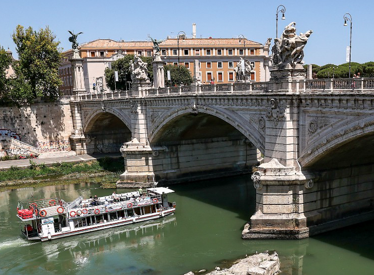 A sightseeing tourist boat sails past the resurfaced remains of an ancient bridge, which was possibly built under Roman Emperor Nero, in the Tiber River in Rome, Italy. (Image credit: Photographer: Alessia Pierdomenico/Bloomberg via Getty Images)