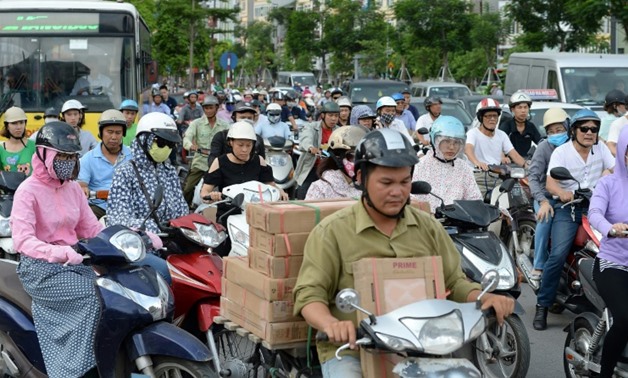 AFP / HOANG DINH Nam  There are five million motorbikes among a population of about seven million in Hanoi, compared to half a million cars on the road
