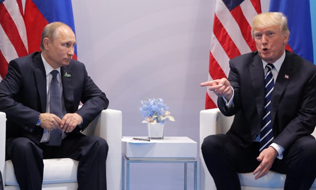 U.S. President Donald Trump gestures as he meets with Russian President Vladimir Putin during their bilateral meeting at the G20 summit in Hamburg, Germany July 7, 2017. REUTERS/Carlos Barria