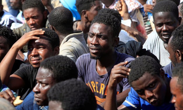 Migrants react after they were rescued by Libyan coastguard, at a naval post in the coastal city of Tripoli, Libya- Reuters