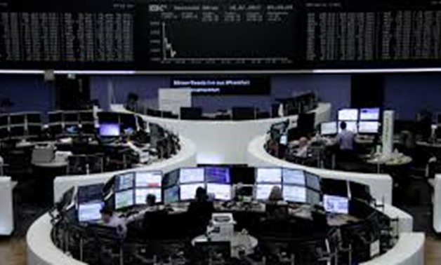 Traders work in front of the German share price index, DAX board, at the stock exchange in Frankfurt, Germany, July 18, 2017.
