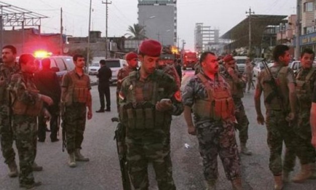 Kurdish security forces gather at the site of a bomb attack in Erbil, the capital of Iraq's Kurdistan region, April 17, 2015. PHOTO: REUTERS