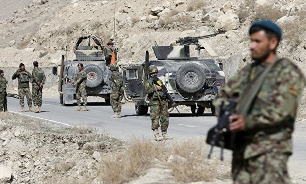 Afghan National Army (ANA) soldiers keep watch at a checkpost in Logar province,
