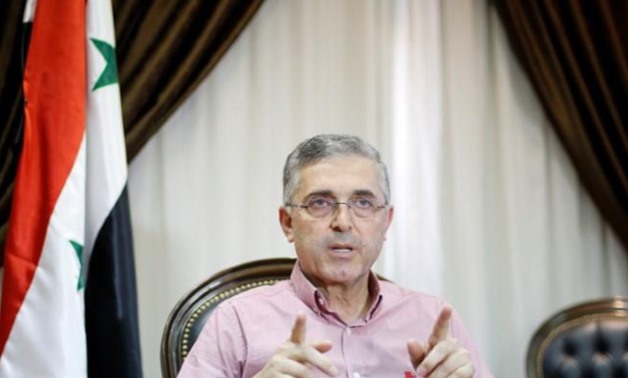 Syria's Minister of National Reconciliation Affairs Ali Haidar gestures as he speaks during an interview with Reuters in his office in Damascus, Syria, July 24, 2017. Picture taken July 24, 2017.