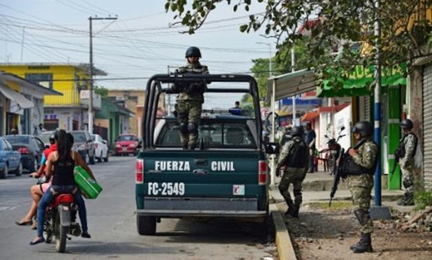 © AFP/File | Mexican police patrol in Veracruz State, where scores of Central Americans being smuggled to the United States have been rescued from an abandoned truck
