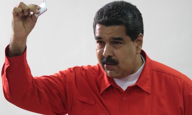 Venezuelan President Nicolas Maduro show his ballot as casts his vote at a polling station during the Constituent Assembly election in Caracas, Venezuela July 30, 2017. Miraflores Palace/Handout via REUTERS
