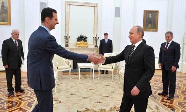 Russian President Vladimir Putin greets his Syrian counterpart Bashar al-Assad during a meeting at the Kremlin in Moscow Getty
