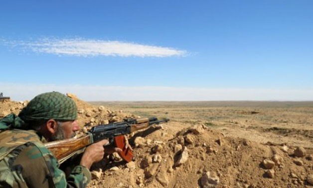 © AFP | In this file picture, a Syrian army soldier takes aim from a position on the outskirts of Syria's Raqa region