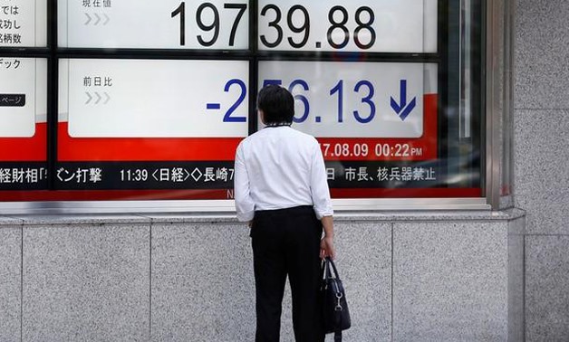 A man looks at an electronic board showing Japan's Nikkei average outside a brokerage at a business district in Tokyo, Japan August 9, 2017.
Kim Kyung-Hoon