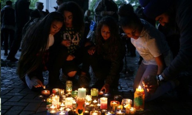 © AFP | People light candles after a silent march in memory of the victims of the Grenfell Tower fire