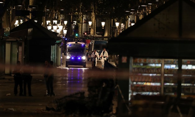 Forensic police officers search for clues near the area where a van crashed into pedestrians at Las Ramblas in Barcelona, Spain, August 17, 2017. REUTERS/Sergio Perez