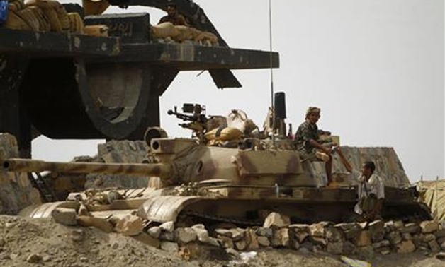 Army soldiers rest at their position on the side of a road to the southern Yemeni province of Abyan June 15, 2012. Yemen's army recaptured the last al Qaeda stronghold in Abyan province on Friday, officials and residents said, and victory appeared close f