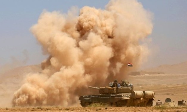 Smoke billows as Iraqi government forces supported by fighters from the Abbas Brigade, which fights under the umbrella of the Shiite popular mobilisation units, advance towards the city of Tal Afar