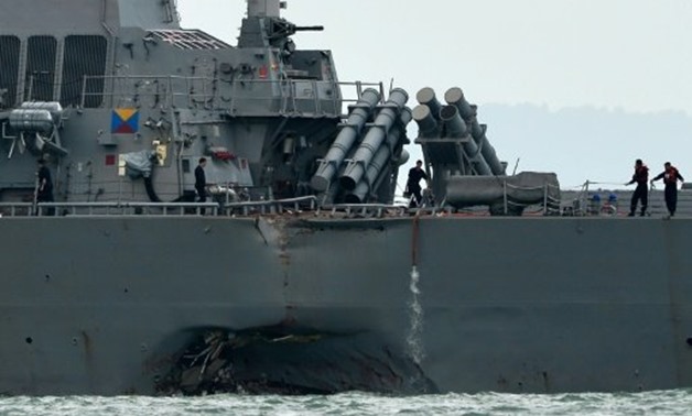 © AFP / by Sam Reeves | A collision between USS John S. McCain and an oil tanker off Singapore left a huge gash in the side of the guided-missile destroyer