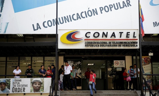 FILE PHOTO: A woman walks out from the building of the National Commission of Telecommunications (CONATEL), in Caracas, Venezuela February 16, 2017.
Marco Bello