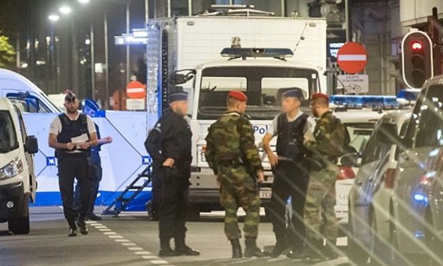 © AFP / by Cédric SIMON | Soldiers and policemen stand guard on the Boulevard Emile Jacqmain in Brussels after soldiers shot dead a knife-wielding attacker