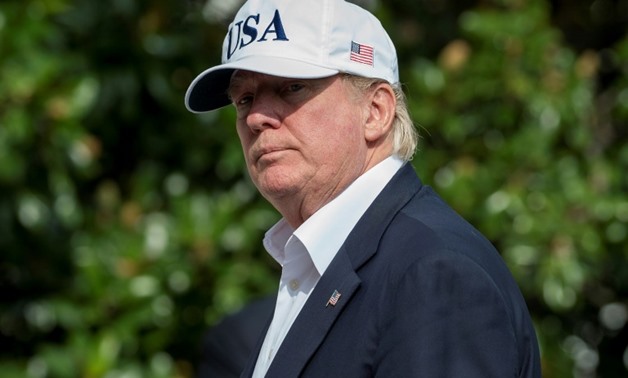 As Harvey pummelled Texas over the weekend, the White House released photos of the president -- decked in a USA cap -- huddling with aides to discuss the response to the storm