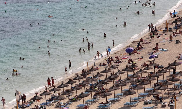 Tourists sunbathe and swim at the beach of Magaluf on the island of Mallorca, Spain, August 19, 2017.