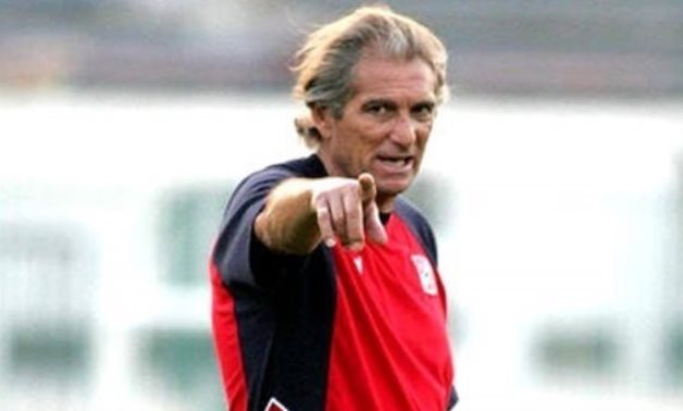 Cairo's head coach Manuel Jose sist on the coach's bench during