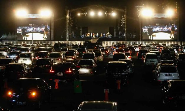 People watch a drive-in concert by local pop band Kahitna during the New Live Experience series, at a parking area of the Jakarta International Expo, amid coronavirus REUTERS/Ajeng Dinar Ulfiana