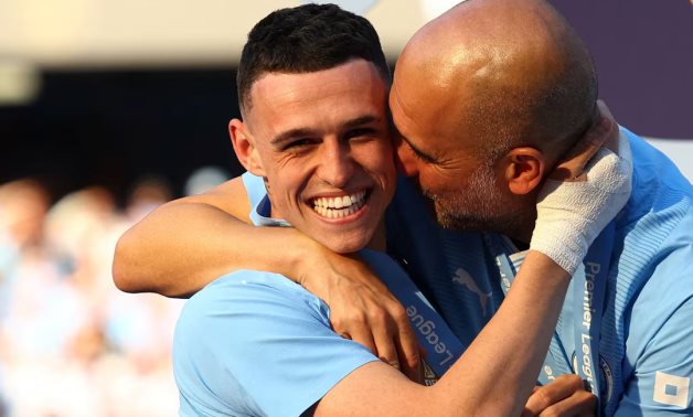 Manchester City manager Pep Guardiola celebrates with Phil Foden after winning the Premier League Action Images via Reuters/Lee Smith/File Photo