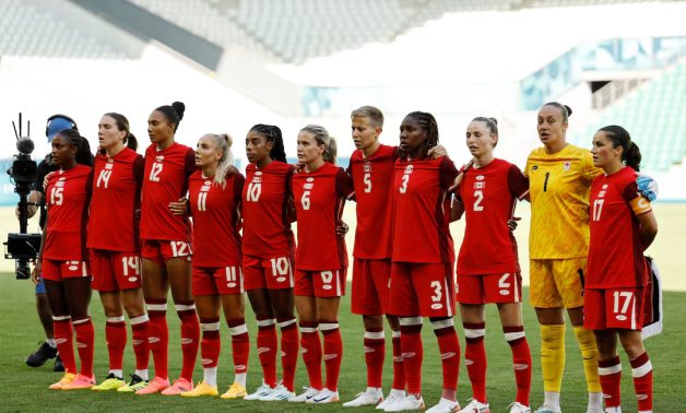 Canada players line up during the national anthems before the match. REUTERS/Thaier Al-Sudani