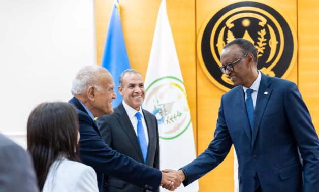 Rwandan President Paul Kagame shakes hands with Sir Madgy Yacoub in presence of Foreign Minister Badr Abdelatty in Kigali- press photo