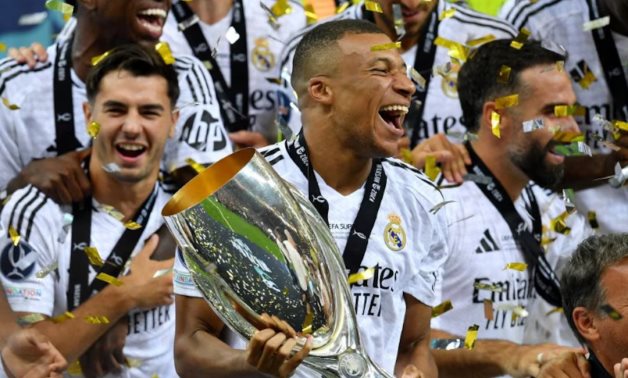 Real Madrid's Kylian Mbappe celebrates with the trophy after winning the Super Cup REUTERS/Jennifer Lorenzini TPX IMAGES OF THE DAY 