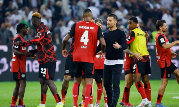 Bayer Leverkusen coach Xabi Alonso with Jonathan Tah celebrate after the match REUTERS/Wolfgang Rattay