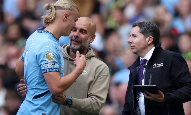 Manchester City manager Pep Guardiola reacts with Erling Haaland after he was substituted REUTERS/Phil Noble 