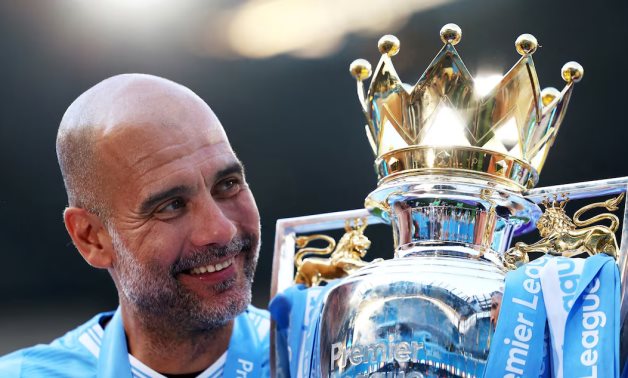 Manchester City manager Pep Guardiola celebrates with the trophy after winning the Premier League Action Images via Reuters/Lee Smith/ File Photo