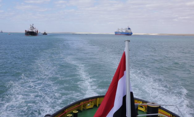 The passage of two vessels through the new Suez Canal’s route following the completion of dredging works on the project- press photo