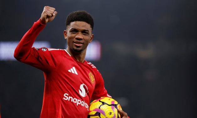 Manchester United's Amad Diallo celebrate after the match as he holds the match ball after scoring a hat trick Action Images via Reuters/Jason Cairnduff 