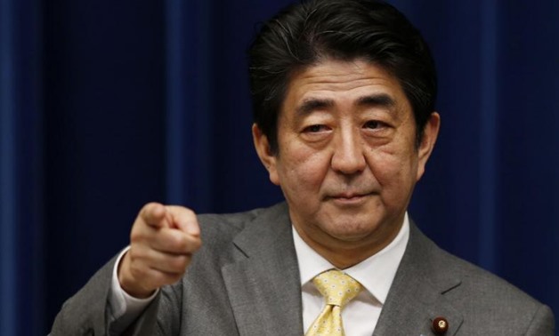 Japan's Prime Minister Shinzo Abe points to a reporter during a news conference at his official residence in Tokyo March 10, 2014, a day before the third anniversary of the March 11, 2011 earthquake, tsunami and nuclear crisis that struck the nation's nor