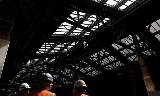 FILE PHOTO: Construction workers are seen at The Moynihan Train Hall in New York City, U.S., August 17, 2017. REUTERS/Brendan McDermid