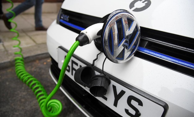 An electric Volkswagen car is plugged into a recharging point in central London, Britain November 10, 2016. REUTERS/Toby Melville/File Photo