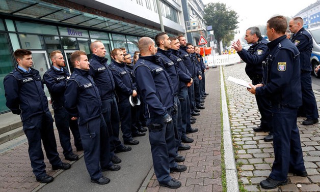 Police officers get their instructions as 60,000 people in Germany's financial capital are about to evacuate the city while experts defuse an unexploded British World War Two bomb found during renovations on the university's campus in Frankfurt, Germany, 