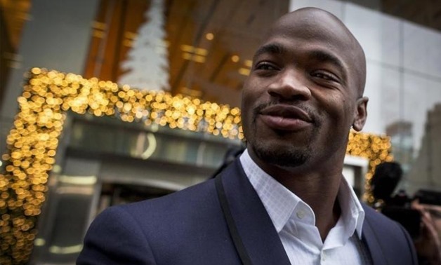 Suspended Minnesota Vikings running back Adrian Peterson exits following his hearing against the NFL over his punishment for child abuse, in New York December 2, 2014. REUTERS/Brendan McDermid