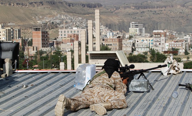 A sniper takes up position as he works on security during a rally to mark three years of the Houthi takeover of Sanaa, Yemen September 21, 2017. REUTERS/Mohamed al-Sayaghi