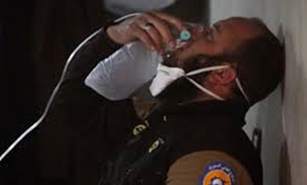 A civil defence member breathes through an oxygen mask, after what rescue workers described as a suspected gas attack in the town of Khan Sheikhoun in rebel-held Idlib, Syria April 4, 2017. REUTERS/Ammar Abdullah