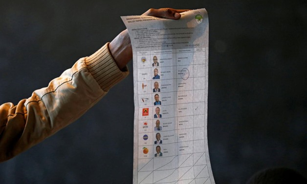 An election official holds up a ballot paper as votes are counted in Nairobi, Kenya October 26, 2017. REUTERS/Thomas Mukoya