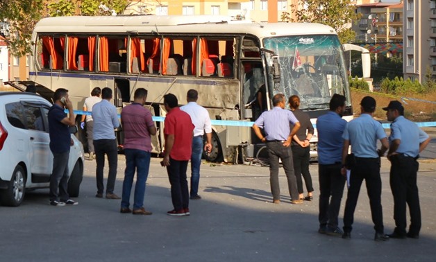 Plainclothes police officers stand after an explosion hit a shuttle bus carrying prison guards in Izmir, Turkey, August 31, 2017. REUTERS/Kemal Aslan