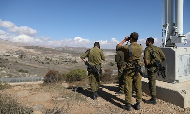 Israeli forces are seen near a border fence between the Israeli-occupied side of the Golan Heights and Syria, November 4, 2017. REUTERS/Ammar Awad