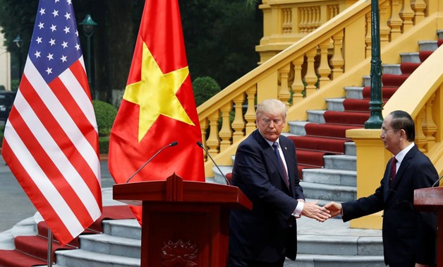 U.S. President Donald Trump (L) and Vietnam's President Tran Dai Quang shake hands after they attended a news conference at the Presidential Palace in Hanoi, Vietnam, November 12, 2017. REUTERS/Kham
