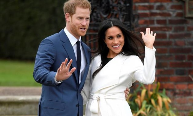 Britain's Prince Harry poses with Meghan Markle in the Sunken Garden of Kensington Palace, London. REUTERS/Toby Melville