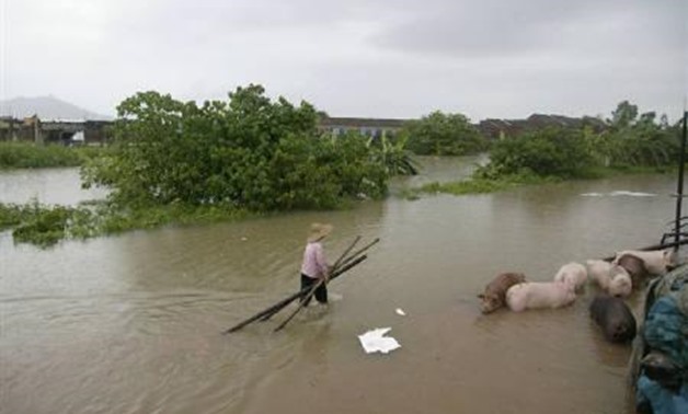 A villager walks in floodwater in Foshan, Guangdong province June 16, 2008. REUTERS