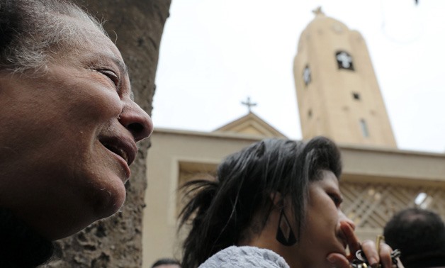 A relative of one of the victims reacts after a church explosion - REUTERS