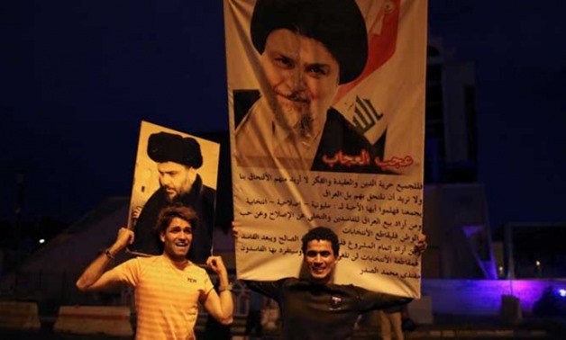 Iraqi supporters of Sairun list celebrate with portraits of Shi'ite cleric Moqtada al-Sadr, after results of Iraq's parliamentary election were announced in Baghdad, Iraq May 14, 2018. REUTERS/Thaier al-Sudani
