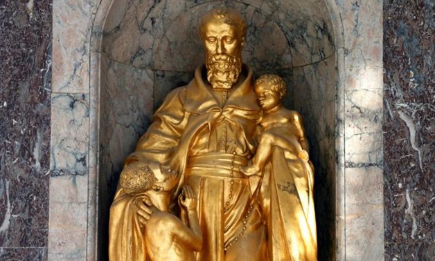 FILE PHOTO: A giant golden statue of a European missionary with an African boy clutching his robes is seen at the Royal Museum for Central Africa in Tervuren, near Brussels, January 22, 2014. Francois Lenoir/File Photo.